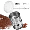 A coffee grinder with ground coffee and coffee beans, with text overlay. Podgląd zdjęcia produktu