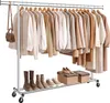A clothing rack with various garments and shoes. Produktbild-Vorschau