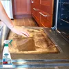 A person is cleaning the inside of an oven with a sponge and a cleaning product. Podgląd zdjęcia produktu