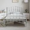 A white metal bed frame with a headboard and footboard, set up in a bedroom with nightstands and a rug. Produktbild-Vorschau