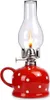 A red and white polka dot oil lamp with a glass chimney and a lit flame. Náhled obrázku produktu