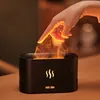 A hand is shown interacting with a black aroma diffuser that emits a flame-like mist. Voir les images du produit