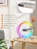 A modern desk lamp with a circular LED light and a floating phone charger, placed on a wooden table. Produktbild-Vorschau