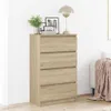 A wooden chest of drawers with decorative items on top, placed against a white wall. Anteprima dell’immagine prodotto