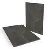 Two vinyl flooring tiles with a stone-like pattern, one lying flat and the other standing upright. Produktbild-Vorschau