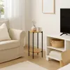 A living room scene with a sofa, a side table, and a TV stand. Podgląd zdjęcia produktu