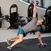 A man is performing a dumbbell exercise in a gym. Náhled obrázku produktu