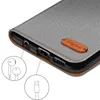 A close-up view of a phone case, highlighting its ports and a small leather tag. Produktbild-Vorschau