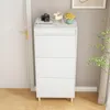 A white shoe cabinet with three drawers is shown in a room with a white door and a light gray wall. Produktbild-Vorschau
