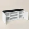 A white shoe cabinet with a black seat on top, shown from the front with one door open. Náhľad obrázku produktu