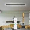 A modern living room with a long, black LED ceiling light and a remote control overlay. Náhľad obrázku produktu