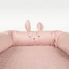 Close-up of a pink baby lounger with a bunny face detail. Produktbild-Vorschau