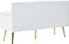 A white shoe cabinet with a padded seat and a backrest, supported by four gold metal legs, shown from a side-rear angle. Anteprima dell’immagine prodotto