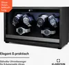 A watch winder with six watches inside, displayed in a dark wood-effect casing with blue interior lighting. Produktbild-Vorschau