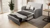 A gray sofa bed is shown in a living room setting with a large window and a plant. Produktbild-Vorschau