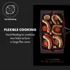 An induction cooktop with food being cooked on it. Náhľad obrázku produktu
