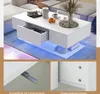 A white coffee table with LED lighting, shown in a living room setting and with close-up details of its features. Voir les images du produit