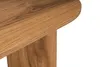 A close-up view of the edge and leg of a wooden table. Voir les images du produit