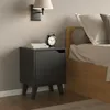 A bedside table next to a bed in a bedroom. Podgląd zdjęcia produktu