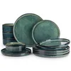 A collection of green and blue stoneware dinnerware, including plates and bowls, arranged on a white background. Voir les images du produit