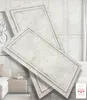 Two decorative wall panels are shown layered on top of each other, with a living room scene in the background. Produktbild-Vorschau