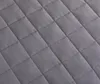 A close-up view of a quilted fabric surface. Podgląd zdjęcia produktu