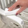A hand is shown cleaning a white chair with a white sponge. Produktbild-Vorschau