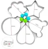 A set of five stainless steel egg rings in various shapes, including a flower, star, circle, heart, and a bear-like shape, are arranged on a white background. Dimensions are indicated with red lines and text. Small blue and green balls are attached to the  Produktbild-Vorschau