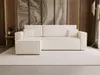 A modern beige sectional sofa with a chaise lounge is shown in a well-lit living room setting.