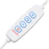 A close-up view of a white remote control with blue buttons and text. Voir les images du produit