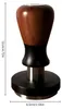 A coffee tamper with a wooden handle and a metal base, with dimensions indicated. Náhled obrázku produktu