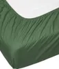 A close-up view of a green fitted sheet on a mattress. Produktbild-Vorschau