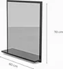 A black framed bathroom mirror with a shelf, shown against a white background with dimensions indicated. Produktbild-Vorschau