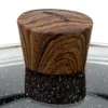 Close-up of a pot lid handle with a wood grain pattern and text. Náhled obrázku produktu
