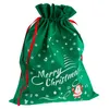 A green Christmas gift bag with a drawstring closure and red ribbons. Produktbild-Vorschau