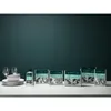 A collection of cleaning products and dishes arranged on a marble countertop against a teal background. Produktbild-Vorschau