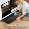 A woman is cleaning the tray of a dog crate. Anteprima dell’immagine prodotto