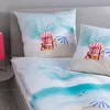 A bed with bedding featuring a beach scene. Produktbild-Vorschau