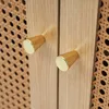 A close-up shot of two wooden cabinet knobs with gold accents. Podgląd zdjęcia produktu