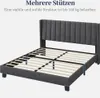 A dark gray upholstered bed frame with a slatted base, shown from a diagonal front-left perspective. Produktbild-Vorschau