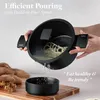 A person is demonstrating the pouring feature of a black pot over a black bowl. Náhľad obrázku produktu