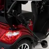 Close-up of the rear of a red three-wheeled vehicle, showing the taillight, wheel, and part of the steering mechanism. Produktbild-Vorschau