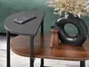 A close-up view of a two-tiered side table with a smartphone on the top shelf and decorative items on the bottom shelf. Podgląd zdjęcia produktu
