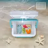 A cooler box filled with food and drinks on a sandy beach with waves in the background. Náhľad obrázku produktu