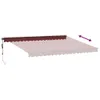 A burgundy awning is shown partially extended from a wall, with a faint outline of its full potential extension. Produktbild-Vorschau