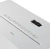 Close-up view of the top surface of a white paper shredder, showing symbols and a control switch. Podgląd zdjęcia produktu