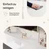 A marketing image showcasing a white, high-gloss TV lowboard with decorative elements and text highlighting ease of cleaning. Voir les images du produit
