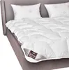 A white duvet and pillows are arranged on a grey bed. Produktbild-Vorschau