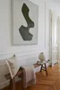 A hallway with a wooden bench, a pillow, a blanket, a lamp, and a large abstract painting on the wall. Anteprima dell’immagine prodotto
