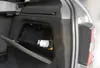 A close-up view of a portable LED work light stored in a compartment in the trunk of a car. Produktbild-Vorschau